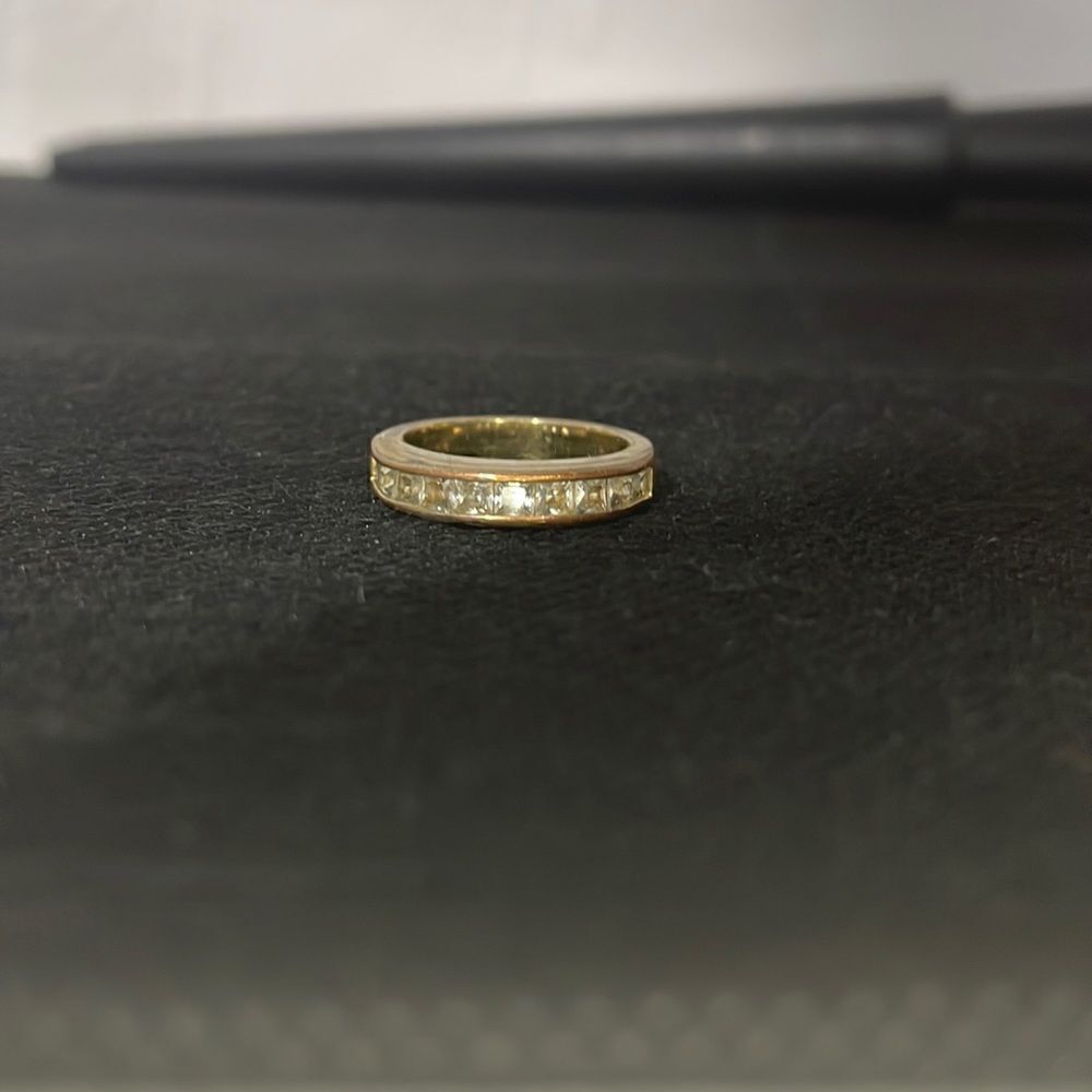 Metal ring with a row of white gems